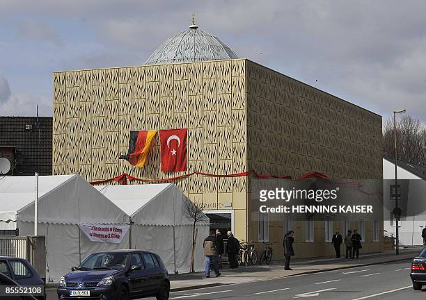 German and a Turkish flag are fixed at the new Kocatepe Mosque during its inauguration on March 22, 2009 in Moers, western Germany. The mosque of the...