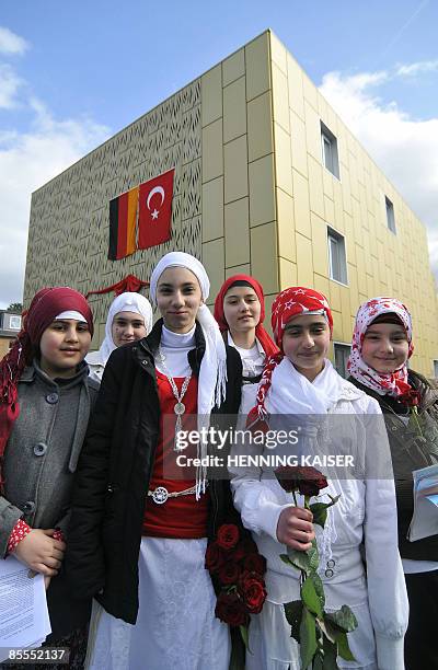 Girls from the muslim community stand in front of the new Kocatepe Mosque during its inauguration on March 22, 2009 in Moers, western Germany. The...