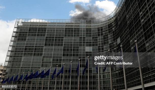 Smoke pours from the roof of the European Commission building on May 18 touching off fire alarms and forcing the evacuation of the EU headquarters....