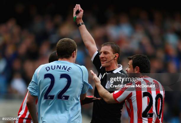 Andy Ried of Sunderland and Richard Dunne of Manchester City argue with Steve Tanner during the FA Barclays Premier League match between Manchester...