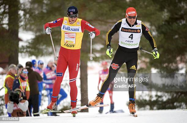 Norway's Petter Northug and Germany's Tobias Angerer compete in the men's 15 km pursuit during the Cross Country skiing world cup in Falun, on March...