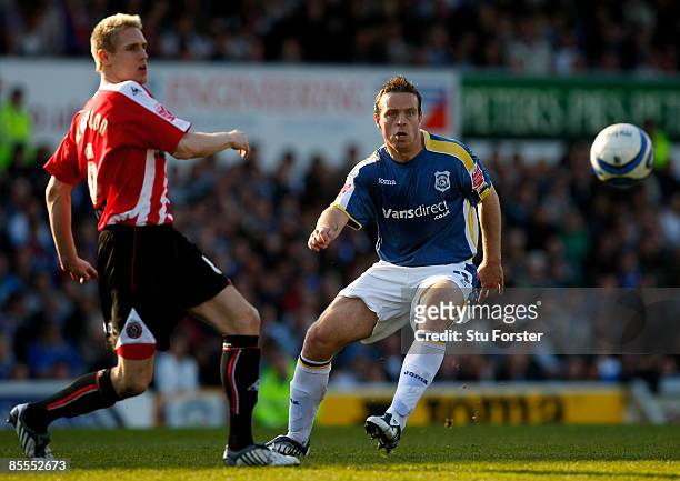 Cardiff City player Stephen McPhail holds off the challenge of Matthew Kilgallon of Sheffield United during the Coca Cola Championship match between...