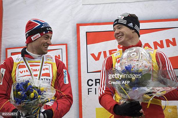 Switzerland's Dario Cologna celebrates on the podium his victory in the Cross Country skiing world cup with Norway's Petter Northug, placed second,...