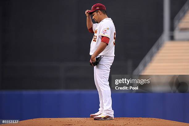 Starting pitcher Carlos Silva of Venezuela reacts after Hyun-Soo Kim of Korea hits a single to score Yong-Kyu Lee in the first inning of the...