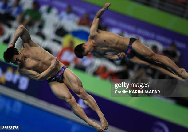 China's Qin Kai and Wang Feng compete in the men's 3m springboard synchronised diving final during the FINA Diving World Series 2009 at the Hamad...