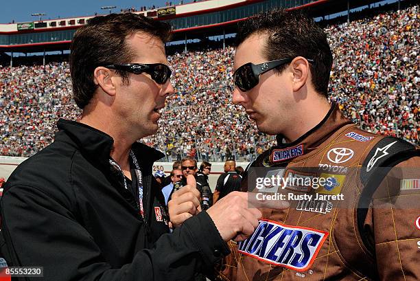 Team owner J.D. Gibbs talks with Kyle Busch, driver of the Snickers Toyota, on the grid prior to the NASCAR Sprint Cup Series Food City 500 at...