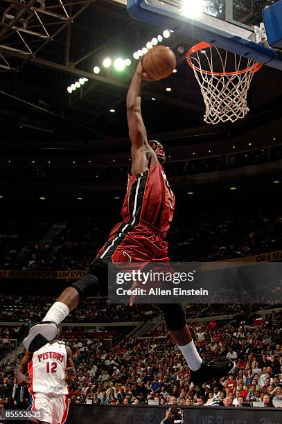 Dwyane Wade of the Miami Heat goes up for a break away dunk past Will Bynum of the Detroit Pistons in a game at the Palace of Auburn Hills on March...