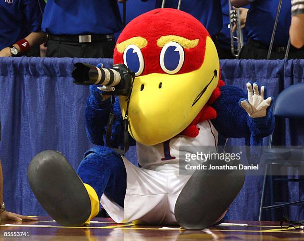 Jayhawk, the mascot for the Kansas Jayhawks takes pictures with a camera from the photographer row against the Dayton Flyers during the second round...