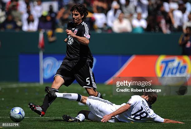 Dejan Jakovic of D.C. United fights for the ball with Mike Magee of the Los Angeles Galaxy at the Home Depot Center on March 22, 2009 in Carson,...