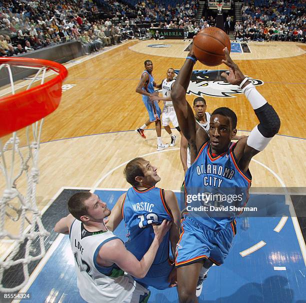 Jeff Green of the Oklahoma City Thunder dunks against Kevin Love of the Minnesota Timberwolves during the game on March 22, 2009 at the Target Center...