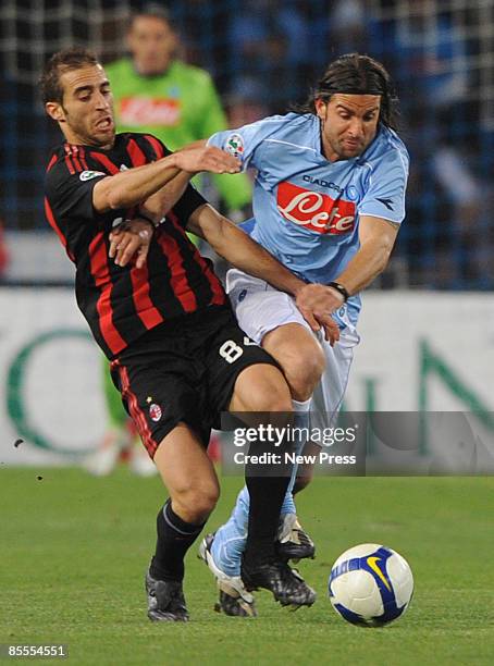 Manuele Blasi of Napoli fends off Mathieu Flamini of Milan during the Serie A match between Napoli and Milan at the Stadio San Paolo on March 22,...