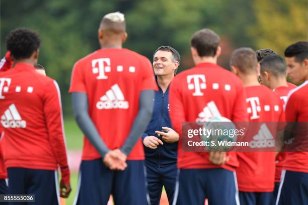 Interim coach Willy Sagnol of FC Bayern Muenchen talks to his players during a training session at Saebener Strasse training ground on September 29,...