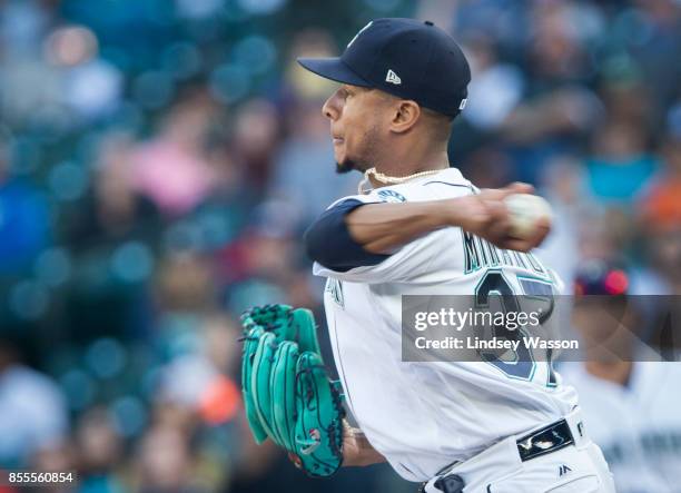 Ariel Miranda of the Seattle Mariners makes a throw to Robinson Cano of that accidentally hits Jean Segura in the hand during the game against the...