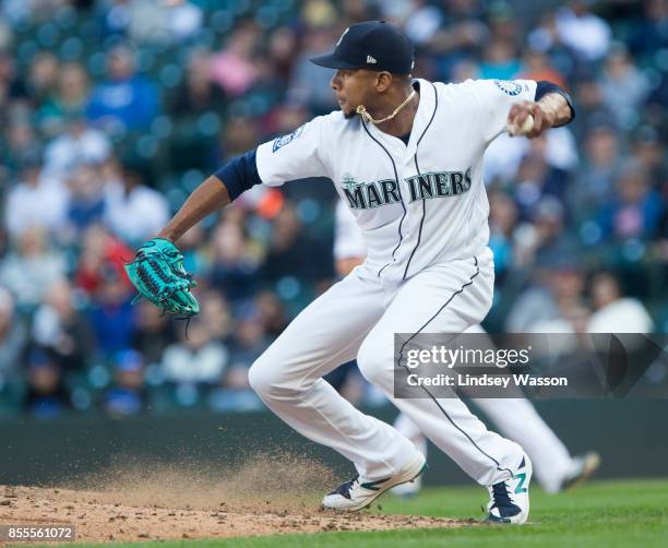 Ariel Miranda of the Seattle Mariners makes a throw to Robinson Cano of that accidentally hits Jean Segura in the hand during the game against the...