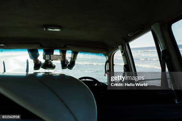 legs tangling on windscreen of surfer’s car - car from the top stock pictures, royalty-free photos & images