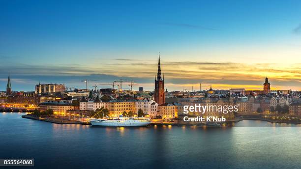 sunset over riddarholmen chruch in old town stockholm city, sweden - stockholm stock pictures, royalty-free photos & images