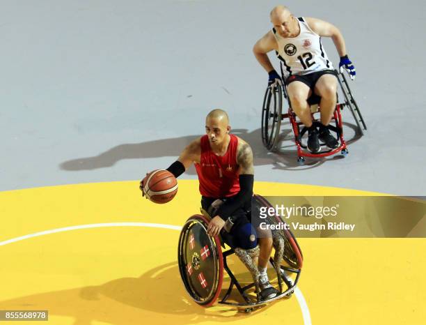 Maurice Manuel of Denmark dribbles the ball as Nicholas Marfell of New Zealand defends in a Wheelchair Basketball pool match during the Invictus...