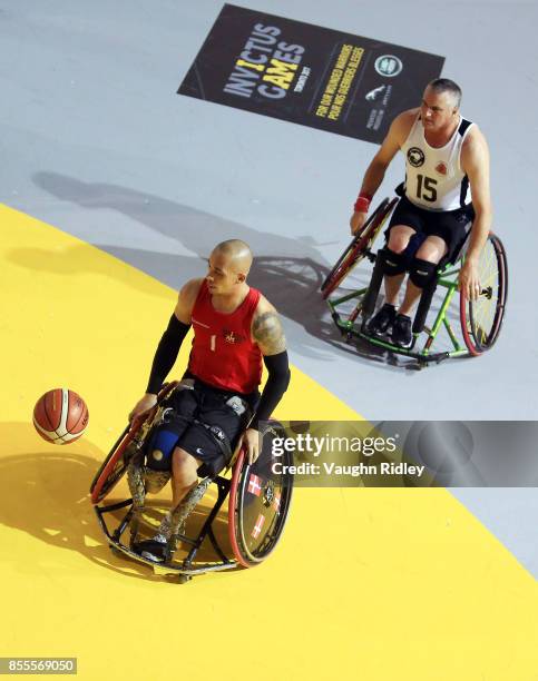 Maurice Manuel of Denmark dribbles the ball as Stephen Fell of New Zealand defends in a Wheelchair Basketball pool match during the Invictus Games...