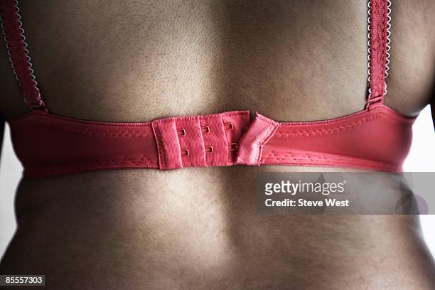 back view of woman wearing bra - too small stockfoto's en -beelden