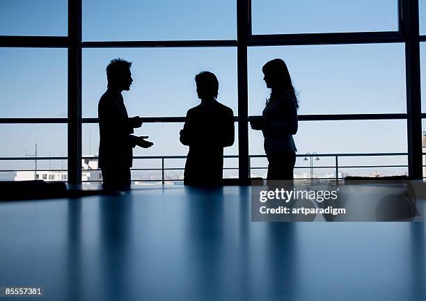 silhouette of business men and woman - businessman silhouette stock pictures, royalty-free photos & images