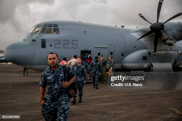 In this U.S. Navy handout, U.S. Marines and Sailors assigned to the 26th Marine Expeditionary Unit exit a KC-130J Super Hercules aircraft attached to...