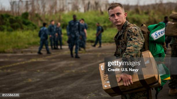In this U.S. Navy handout, U.S. Marine Corps Sgt. Cody M. Freeman, an aviation electrician assigned to the 26th Marine Expeditionary Unit , carries a...