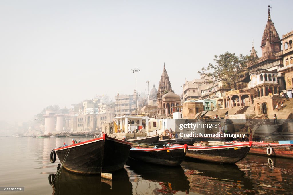 Pleasure boats and ancient Hindu temples on River Ganges