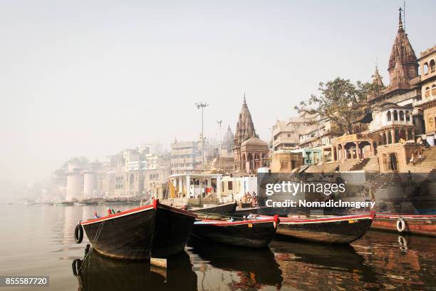 pleasure boats and ancient hindu temples on river ganges - anchored concept stock pictures, royalty-free photos & images