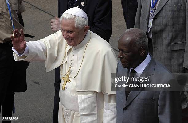 Pope Benedict XVI stands next to Angolan President Jose Eduardo Dos Santos as he waves goodbye to a cheering crowd on March 23, 2009 at the Luanda's...