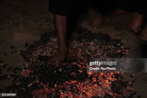 Shiite Muslims walk over burning coal during religious procession during the month of Muharram-ul-Haram which is the first month of the Islamic...