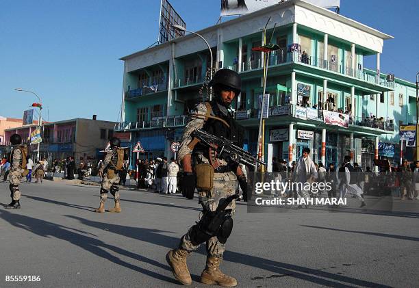 Afghan border policeman stand guard in front of the Hazrat Ali Shrine in the northern town of Mazar-i-Sharif in Balkh province on March 20, 2009....