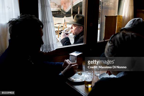 Man drinks a typical aperitif in Canareggio quarter on February 13, 2009 in Venice, Italy.