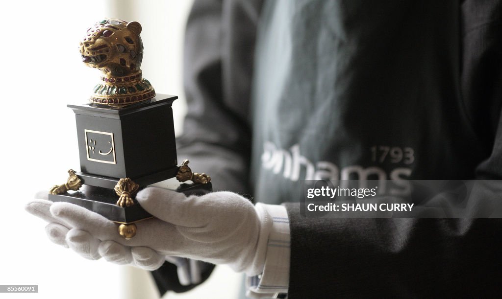A Bonhams auction house employee holds a