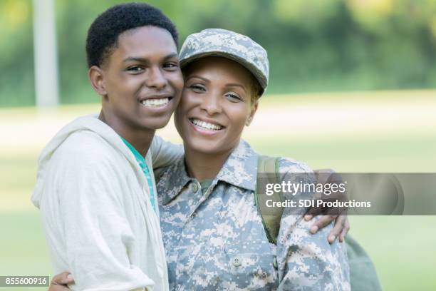 military mom hugs her teenage son - mother son reunited stock pictures, royalty-free photos & images
