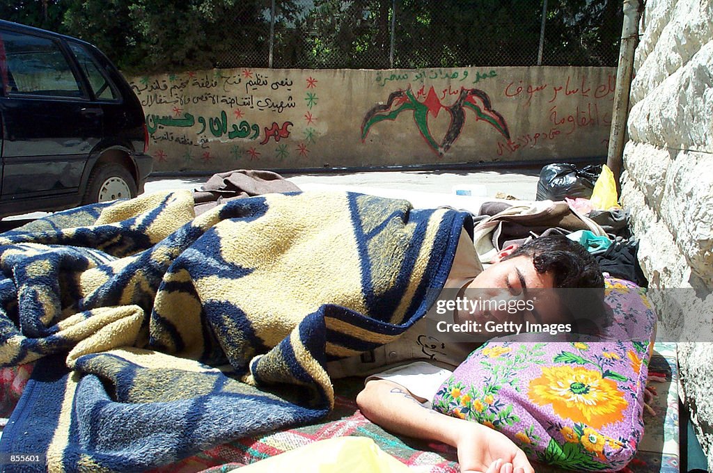 Young Palestinian Sleeps Next to Hospital