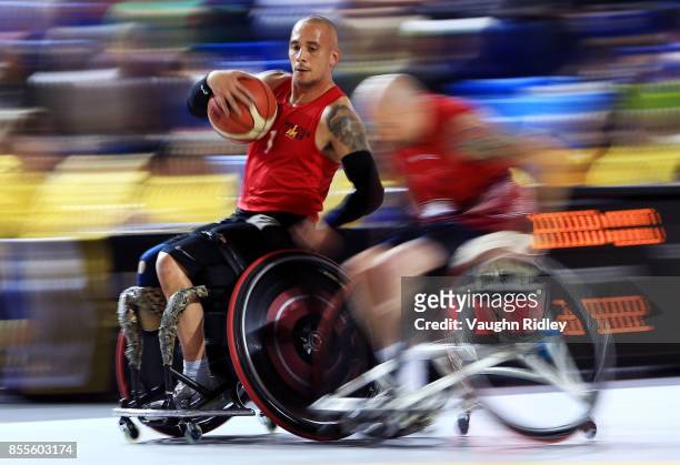 Maurice Manuel of Denmark dribbles the ball as David Scott of the United Kingdom defends in a Wheelchair Basketball pool match during the Invictus...