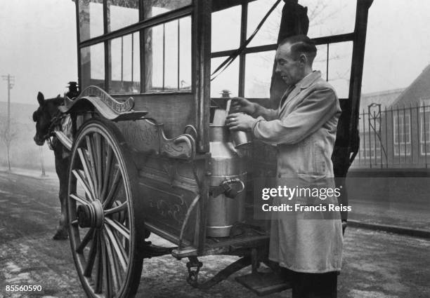 Ex-serviceman Trevor Ingham, who now helps his father to run a dairy business at Whitefield, near Manchester, pouring out a pint of milk from a...