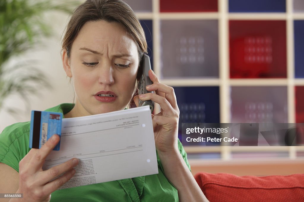 Woman paying bills by phone