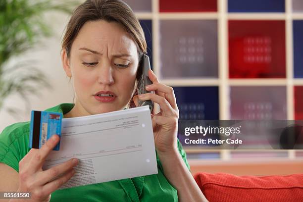 woman paying bills by phone - worried 個照片及圖片檔