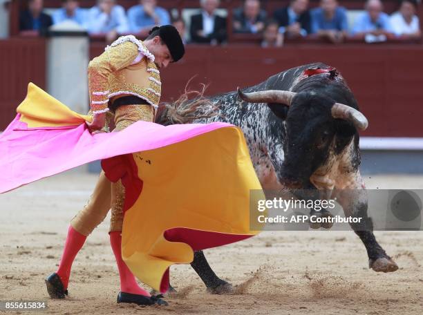 Spanish matador Paco Urena performs a pass on a bull during the Fall bullfighting festival at Las Ventas bullring in Madrid on September 29, 2017 /...