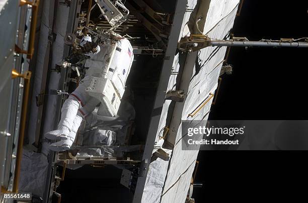 In this handout photo provided by NASA, Astronaut Steve Swanson, STS-119 mission specialist, participates in the mission's second scheduled session...