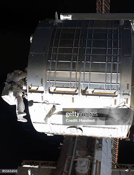 In this handout photo provided by NASA, Astronaut Steve Swanson, STS-119 mission specialist, participates in the mission's second scheduled session...