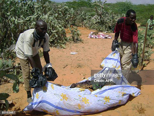 Somali men carry the remains on March 22, 2009 of individuals that were allegedly shot by Ethiopian troops during their occupation of parts of...