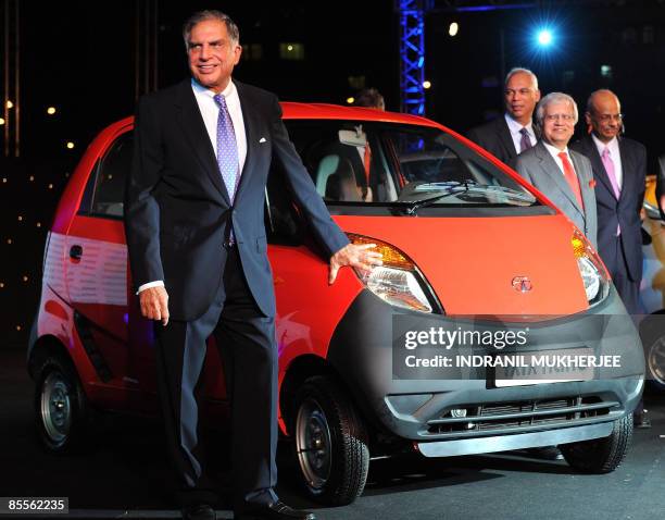 Tata Group chairman Ratan Tata poses with a Nano car during the vehicle's launch in Mumbai on March 23, 2009. Tata Motors took the wraps off the...