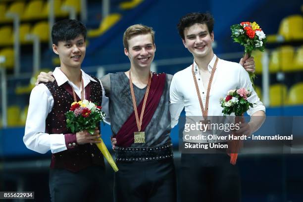 Joseph Phan of Canada with the silver medal, Alexei Krasnozhon of United States with the gold medal and Makar Ignatov of Russia with the bronze medal...