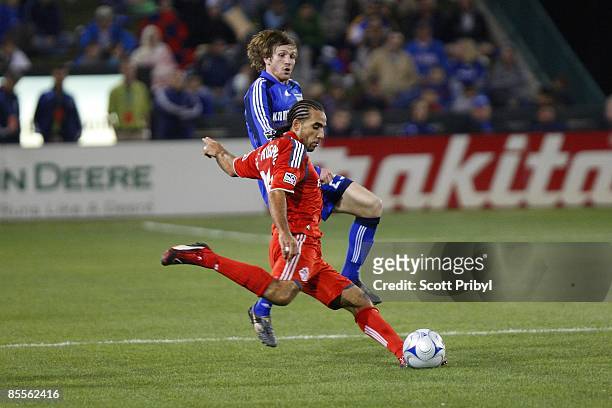 Dwayne De Rosario of Toronto FC crosses the ball against the Kansas City Wizards during the game at Community America Ballpark on March 21, 2009 in...