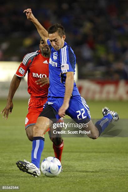 Davy Arnaud of Kansas City Wizards crosses the ball against Toronto FC during the game at Community America Ballpark on March 21, 2009 in Kansas...