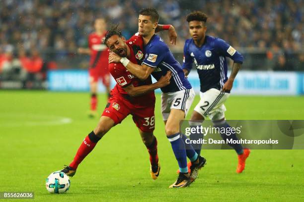 Karim Bellarabi of Bayer 04 Leverkusen is tackled and fould by Matija Nastasic of Schalke 04 during the Bundesliga match between FC Schalke 04 and...