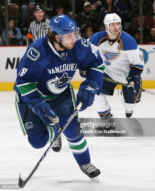 Steve Bernier of the Vancouver Canucks with Barret Jackman of the St. Louis Blues in the background at General Motors Place on March 19, 2009 in...