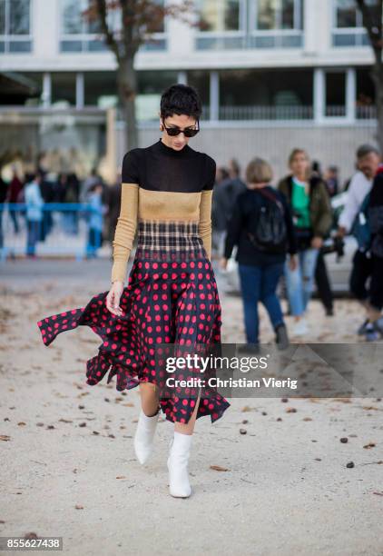 Yasmin Sewell wearing dress with dots print, white ankle boots is seen outside Loewe during Paris Fashion Week Spring/Summer 2018 on September 29,...